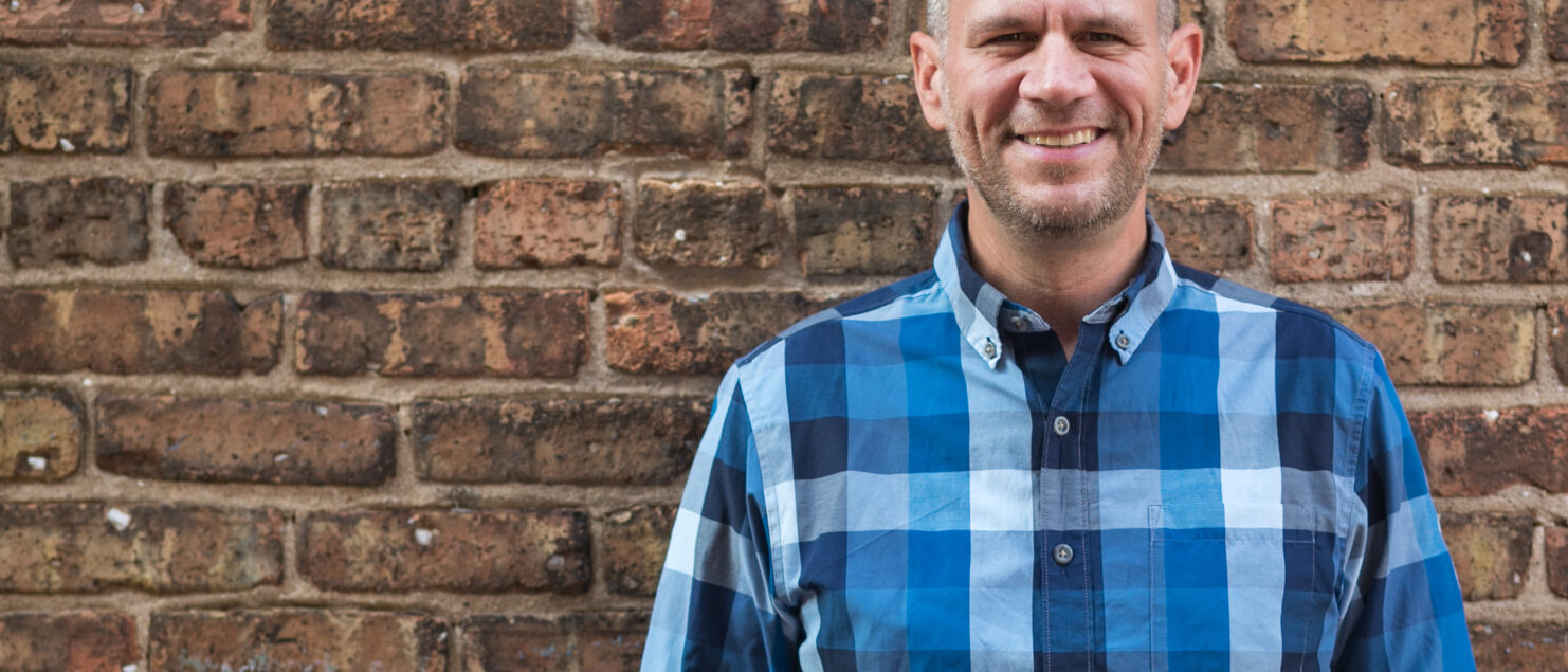 Adam in front of a brick wall - important qualities in running a business