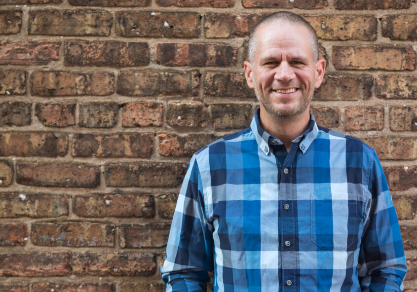 Adam in front of a brick wall - important qualities in running a business