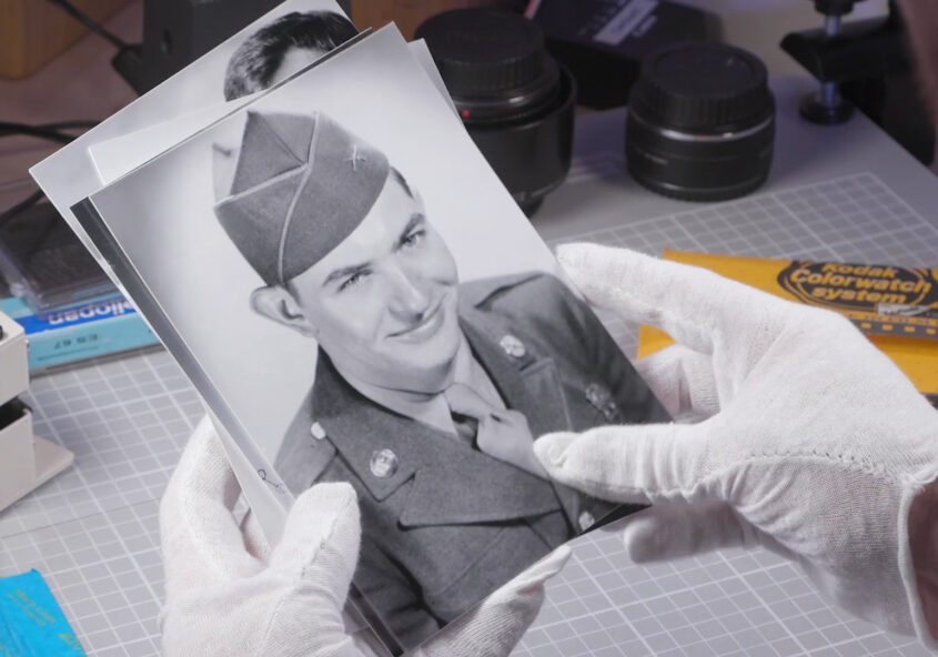 hands in gloves holding vintage photos - how to choose a scanning company